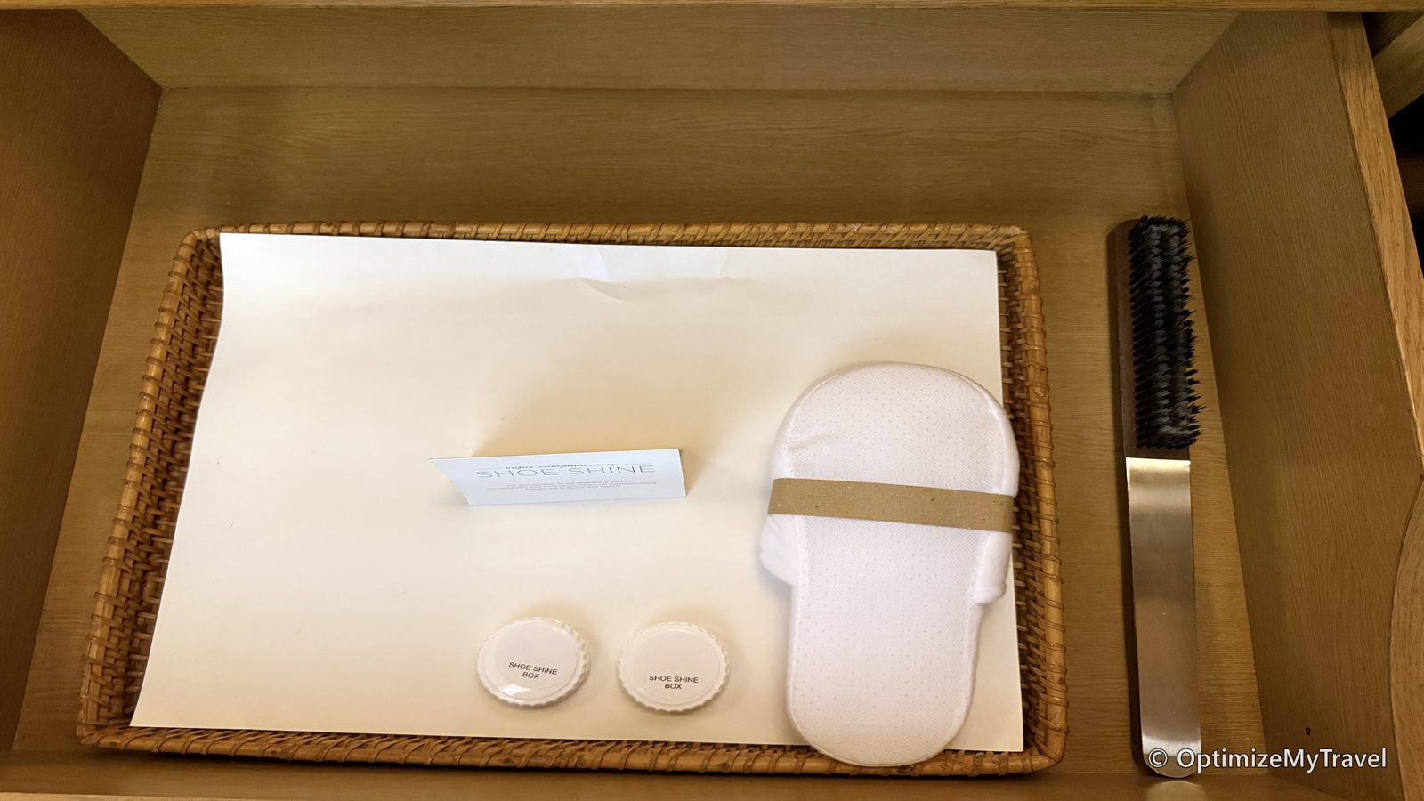 Hotel slippers and shoe-shine supplies arranged on a tray