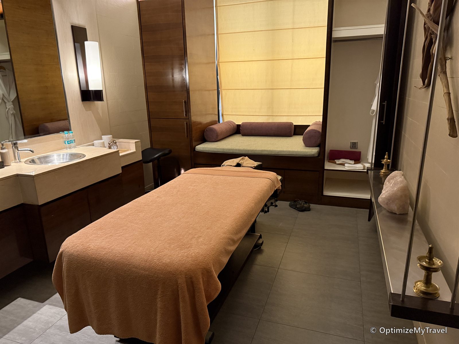 Private massage treatment room with a treatment table and seating