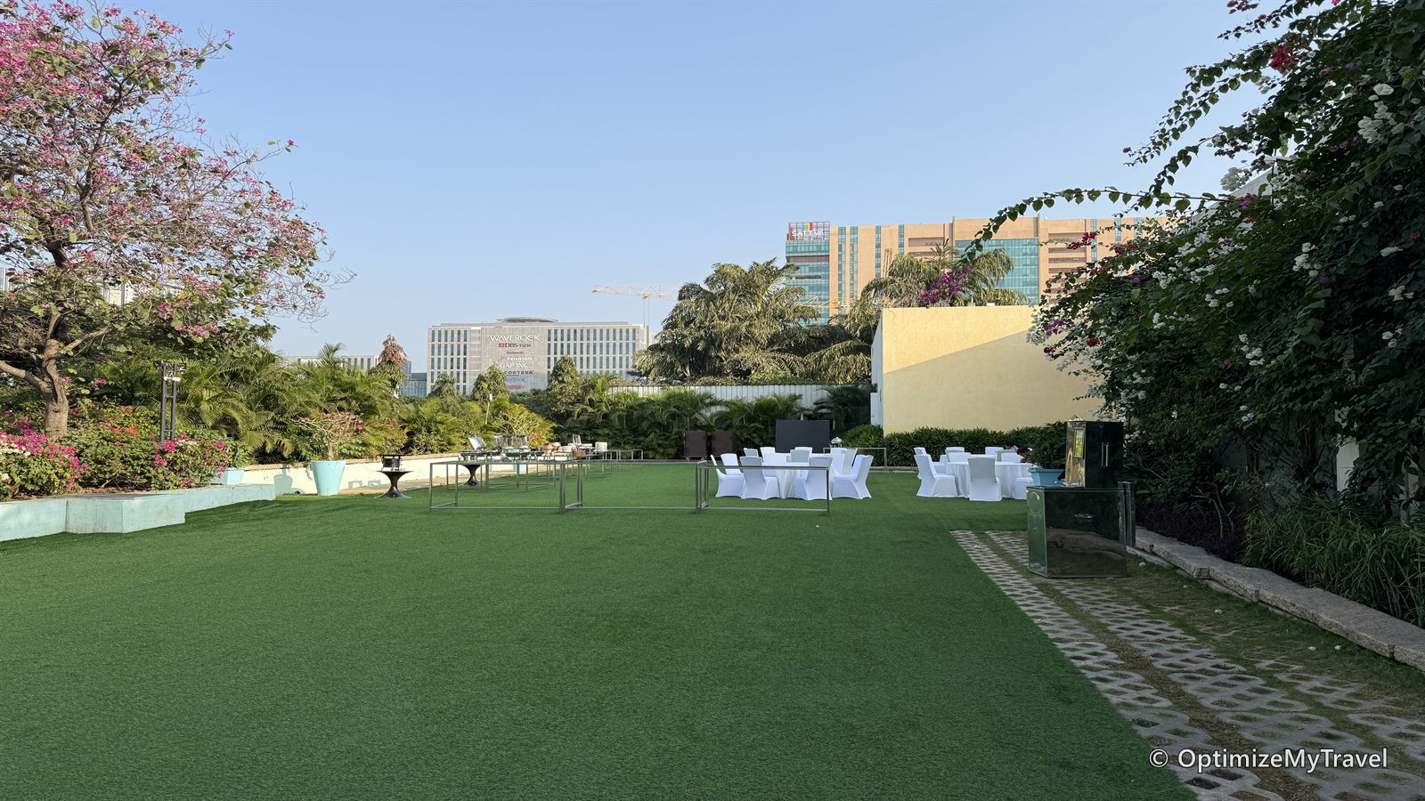 Outdoor event lawn prepared with rows of white chairs